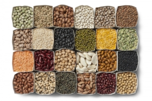 Variety of dried beans and lentils in bags on white background